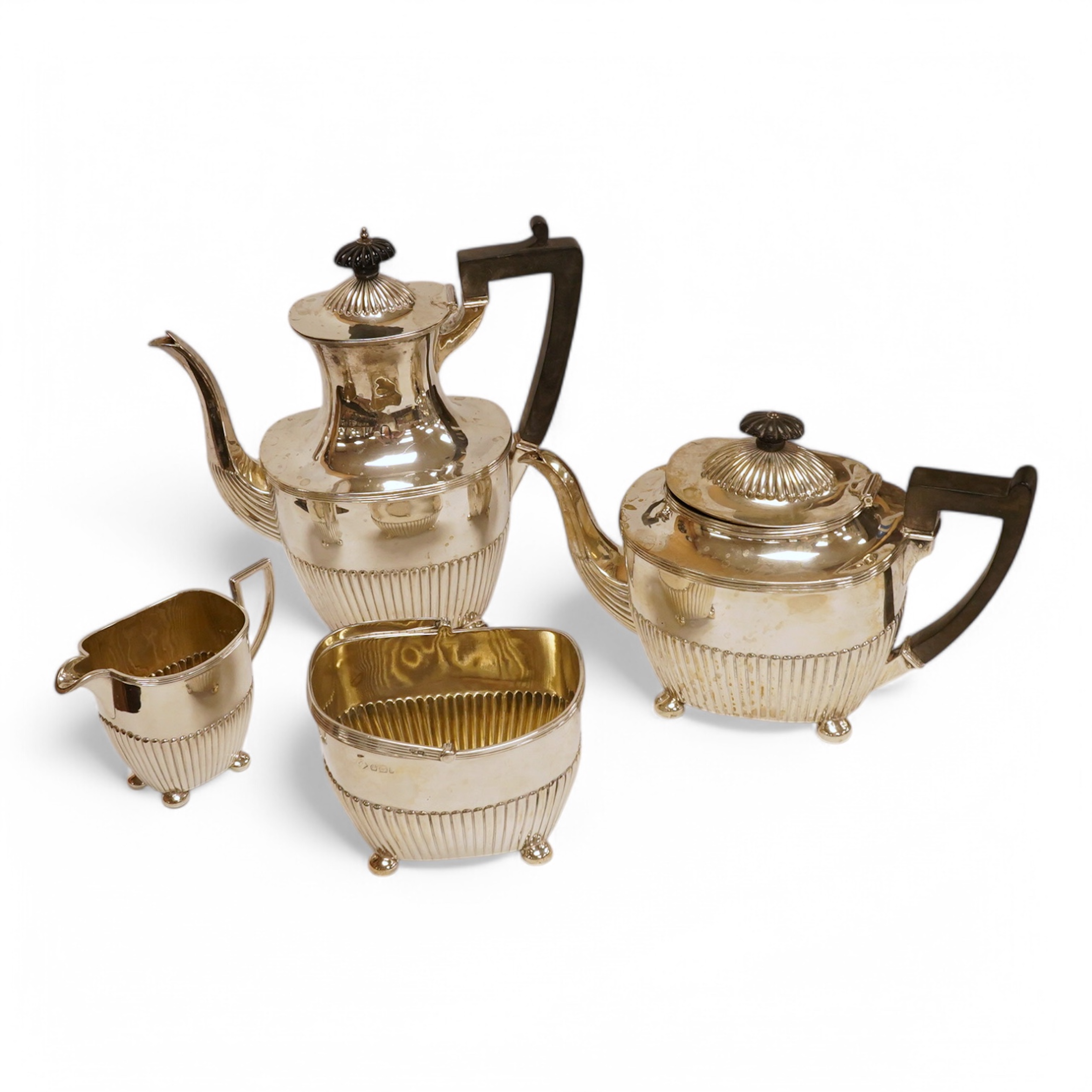 A late 19th/early 20th century demi-fluted silver four piece tea and coffee set, by Martin, Hall & Co, Sheffield, 1893, 1896, 1903 & 1907, gross weight 52.8oz. Condition - poor to fair